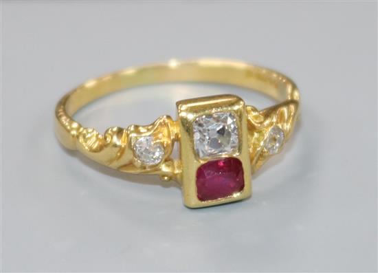 A modern 18ct gold, ruby and diamond two stone ring with diamond set shoulders, size M.